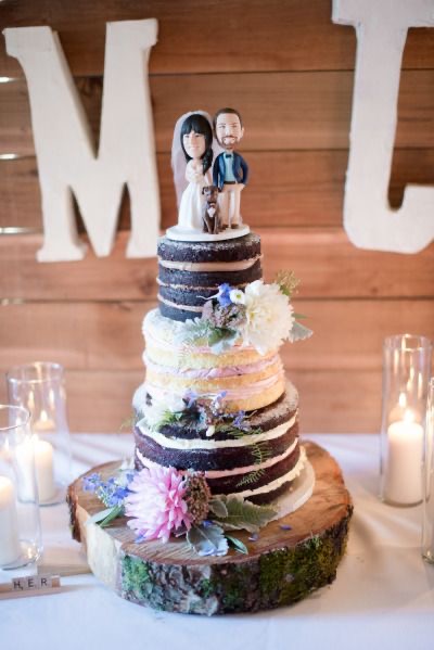 naked cake with super cute cake toppers of the couple and their pet
