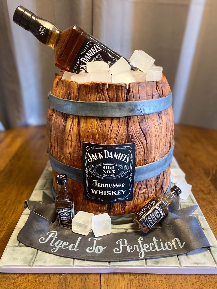 'Whiskey barrel cake' with Jack Daniels bottle as cake topper