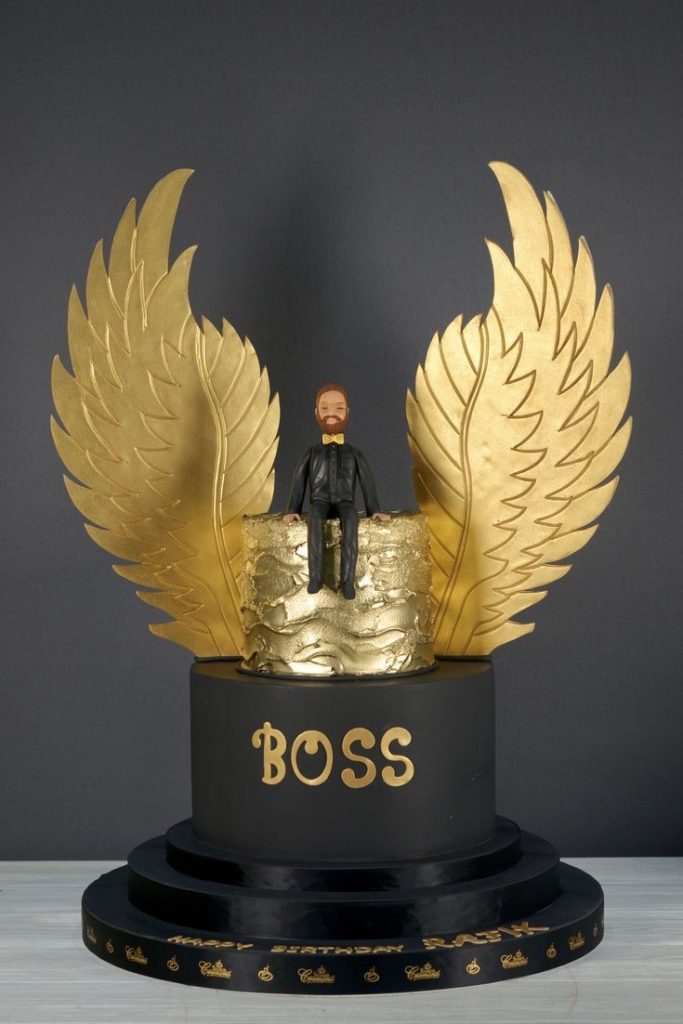Golden Wings cake with Boss as the theme and a mini figurine cake topper
